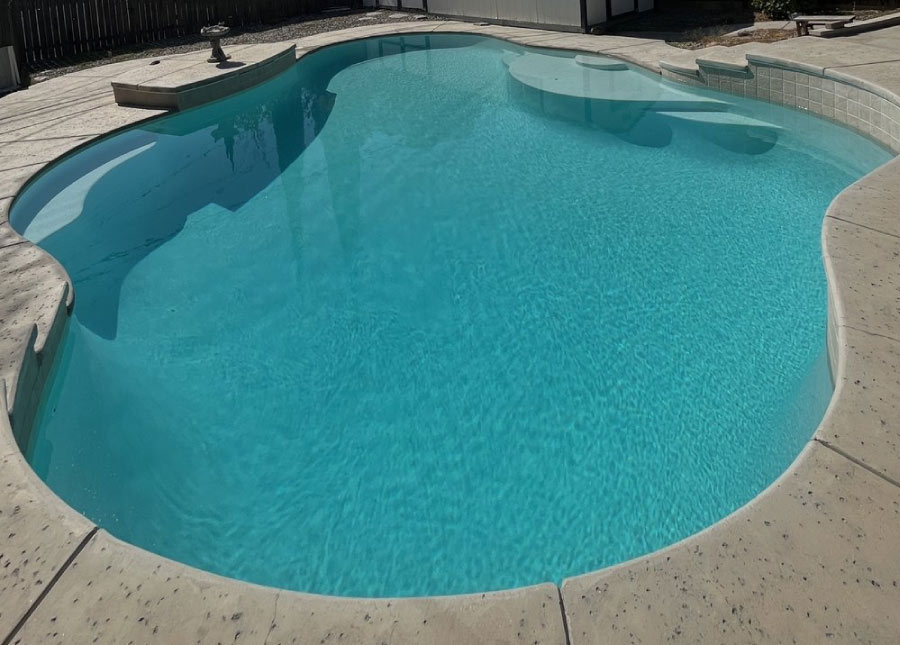 A completed residential pool replacement in Kern County featuring crystal clear water and a premium smooth plaster finish backed by a 2-year workmanship warranty.